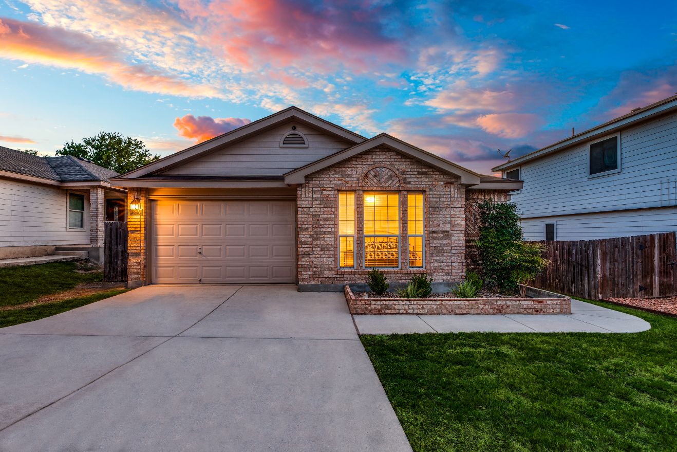 Single-story brick home at sunset